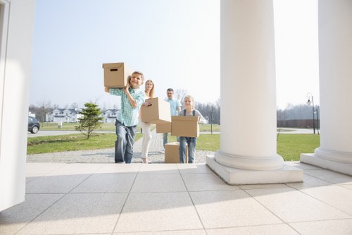 Moving crew handling flat removals in a Kensington apartment building