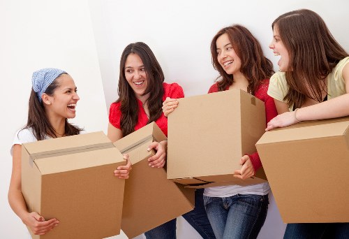 A moving team handling household items in Kensington