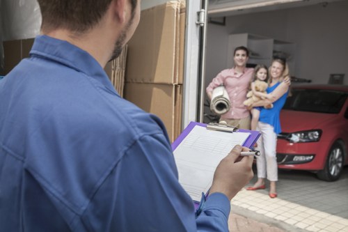 Professional movers navigating stairs and access challenges in a Kensington property